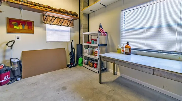 an aerial view of a house with outdoor seating