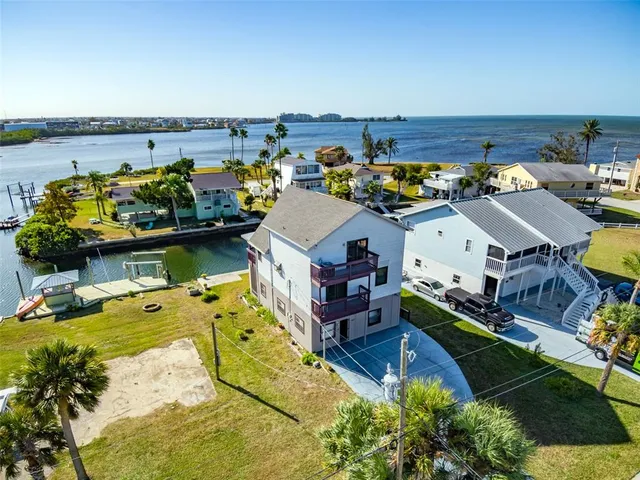 a view of a lake with boats and large trees