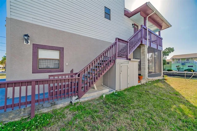 a view of a house with a yard and deck
