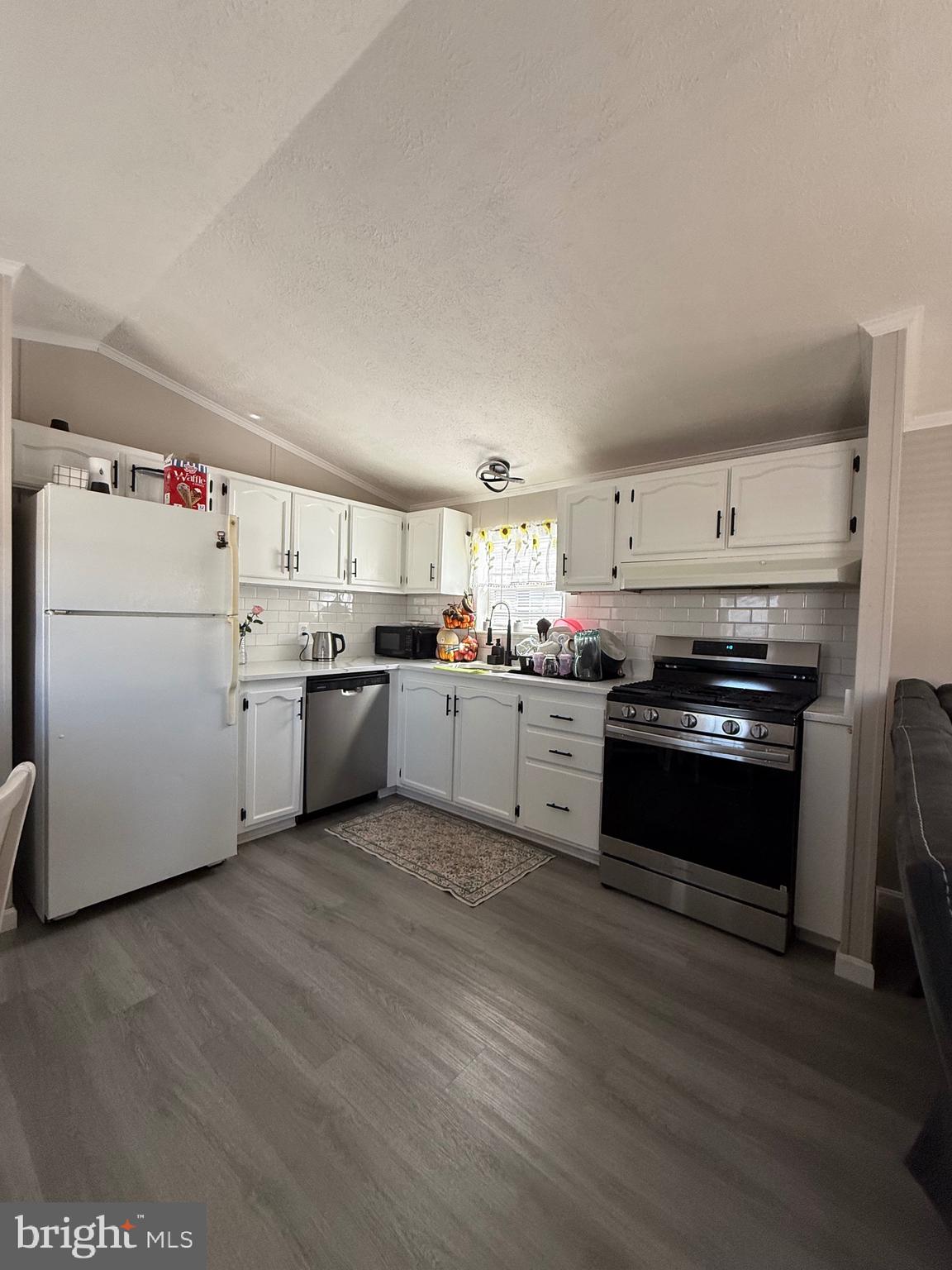 7959 Telegraph Road Severn, MD 21144 - Photo 10 of 18 a kitchen with stainless steel appliances and white cabinets