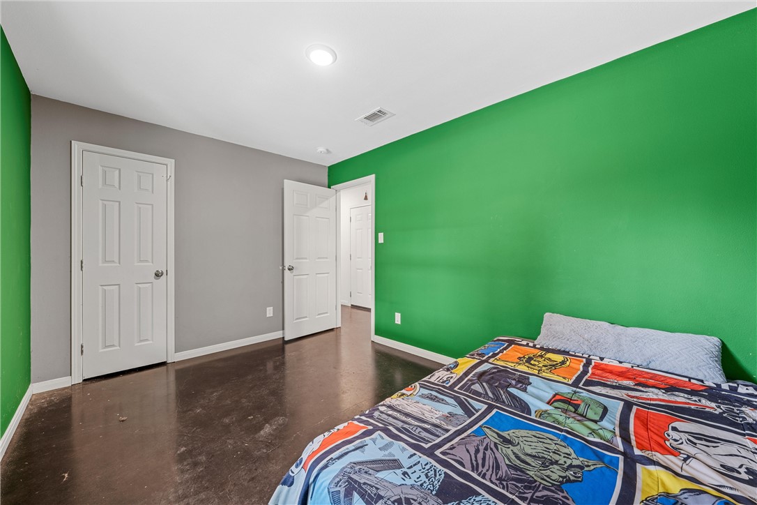 306 Randy Drive Woodway, TX 76712 - Photo 13 of 26 a bedroom with a bed and a dresser