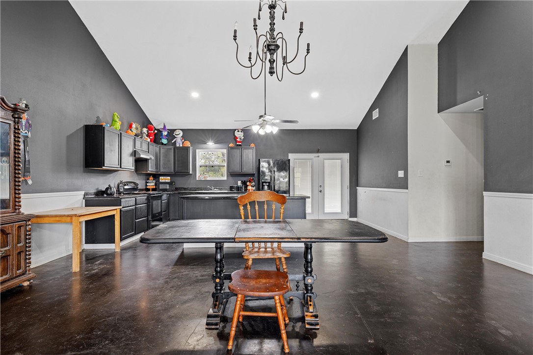 306 Randy Drive Woodway, TX 76712 - Photo 7 of 26 a kitchen with stainless steel appliances kitchen island granite countertop a stove top oven a sink a dining table and chairs with wooden floor