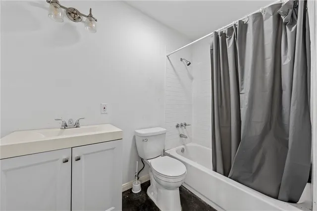 a white toilet sitting next to a bathroom sink