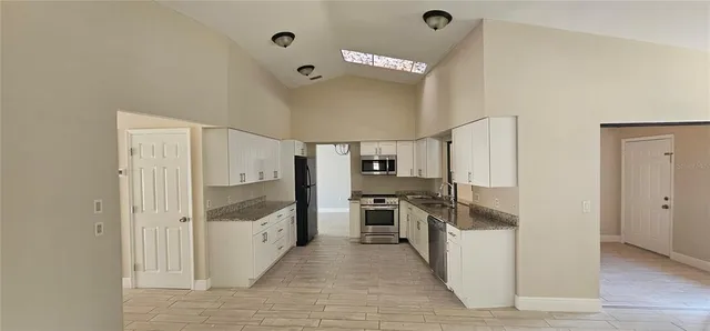 a kitchen with stainless steel appliances a refrigerator and a stove
