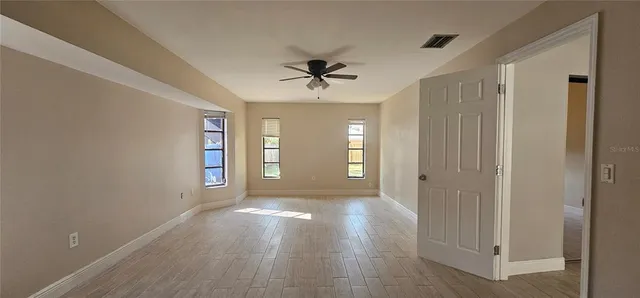 wooden floor in an empty room with a window