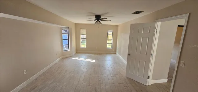 wooden floor in an empty room with a window