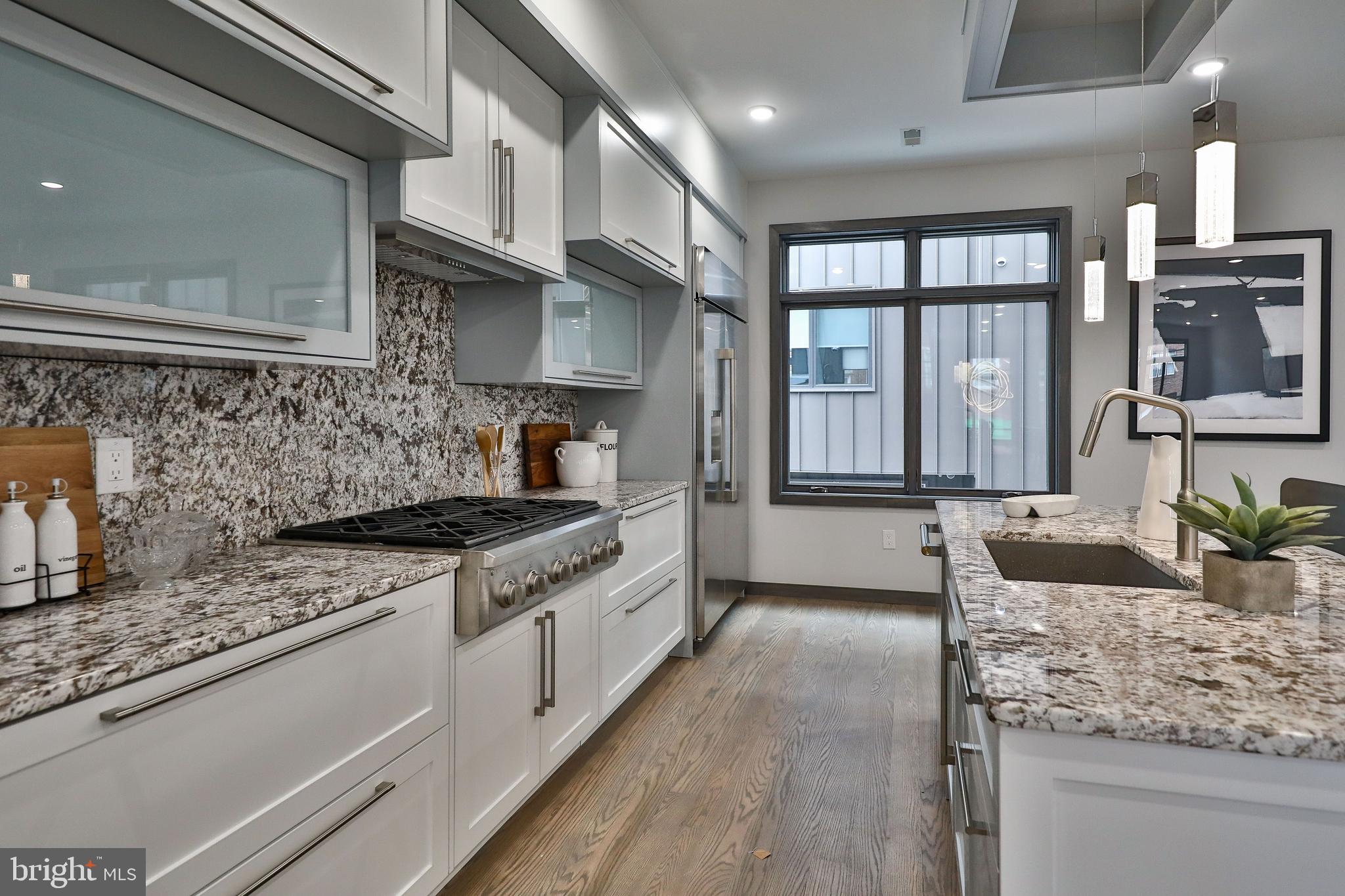 1024 Christian Street Philadelphia, PA 19147 - Photo 18 of 44 a kitchen with stainless steel appliances granite countertop a sink stove and cabinets