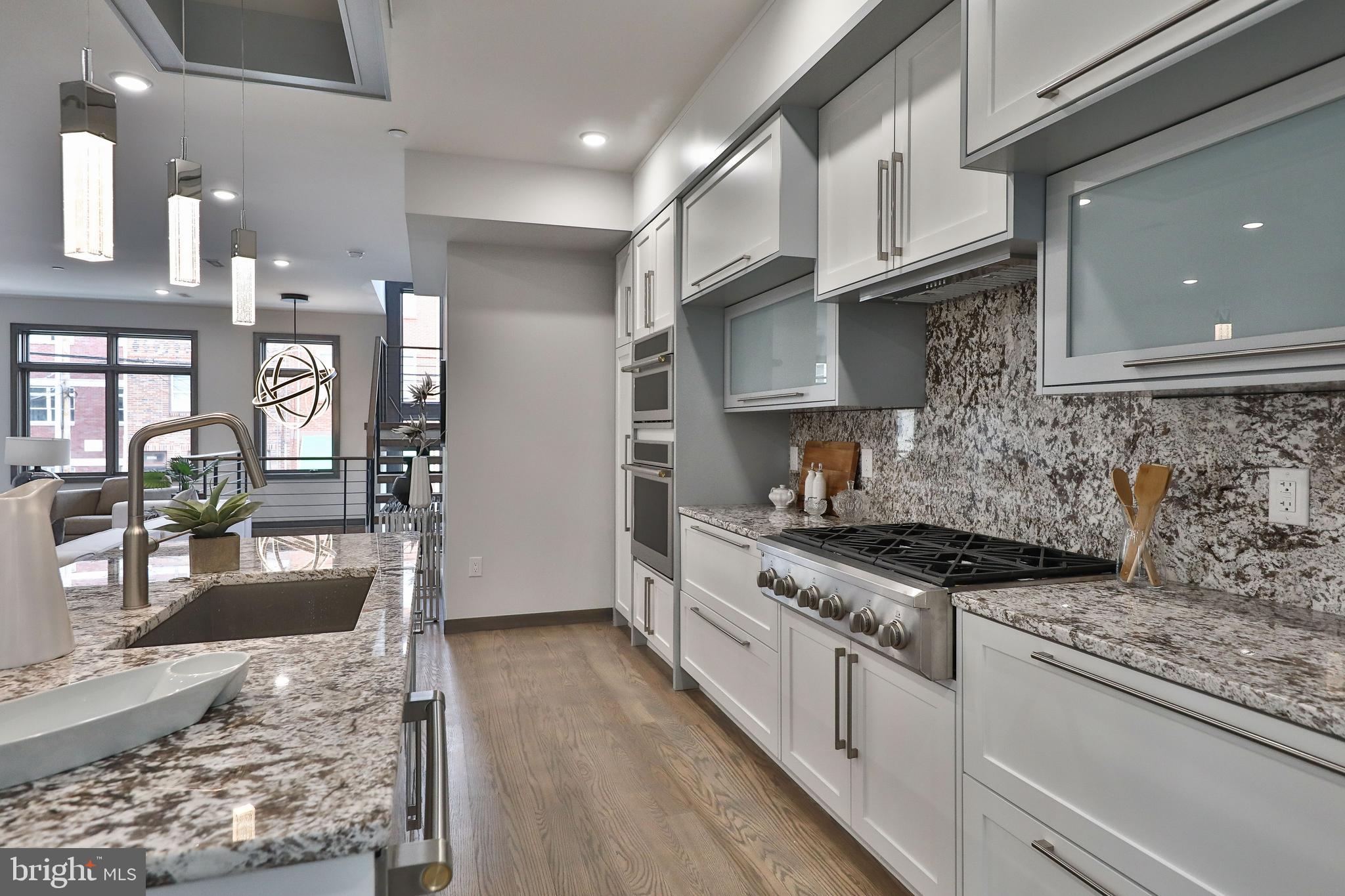 1024 Christian Street Philadelphia, PA 19147 - Photo 19 of 44 a kitchen with stainless steel appliances granite countertop a stove and a wooden floors
