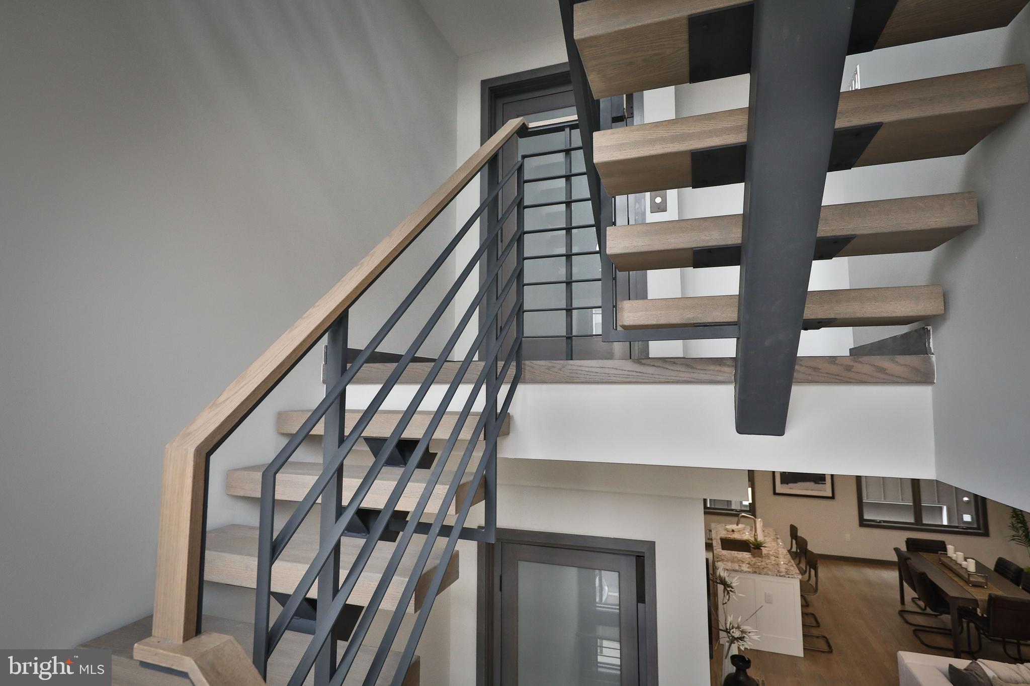 1024 Christian Street Philadelphia, PA 19147 - Photo 22 of 44 a view of staircase with lots of frames on wall and a window
