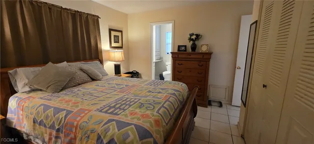 a bedroom with a bed and a dresser