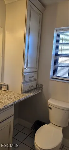 a white toilet sitting next to a bathroom sink