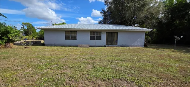 a view of a house with yard and a tree