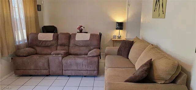 a living room with furniture and a lamp