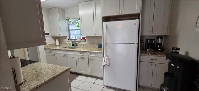 a white refrigerator freezer sitting in a kitchen