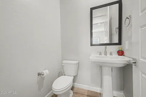 a bathroom with a sink a toilet and mirror