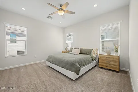 a spacious bedroom with a bed and a window