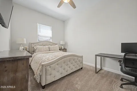 a bedroom with a bed a couch and a window