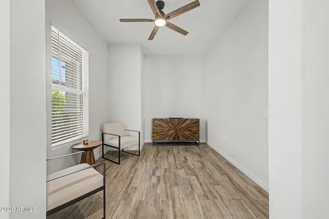 a living room with a bed furniture and a window