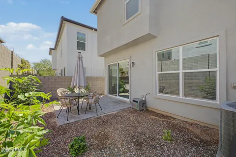 a view of a house with backyard and sitting area