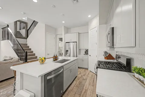 a kitchen with sink and refrigerator