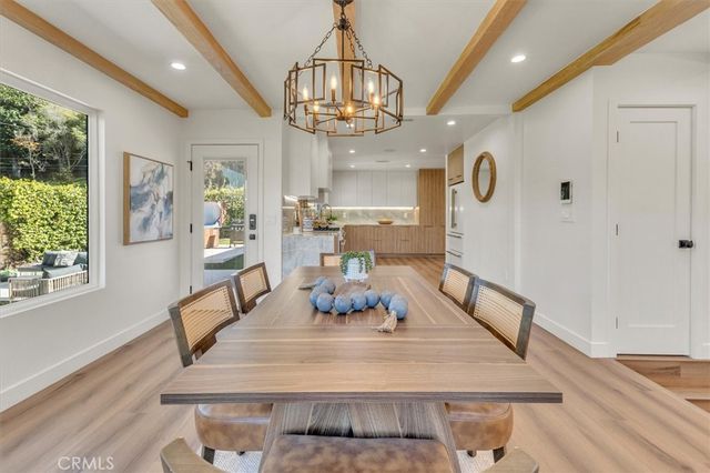a kitchen with stainless steel appliances granite countertop a stove a sink and white cabinets