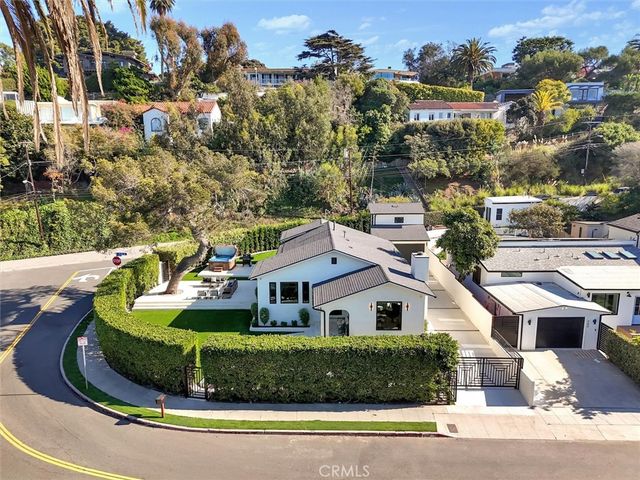 a aerial view of a house with a yard and lake view