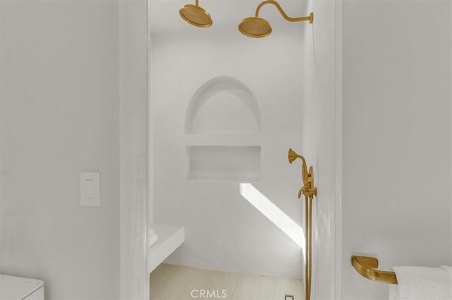 a bedroom with a bed and a mirror