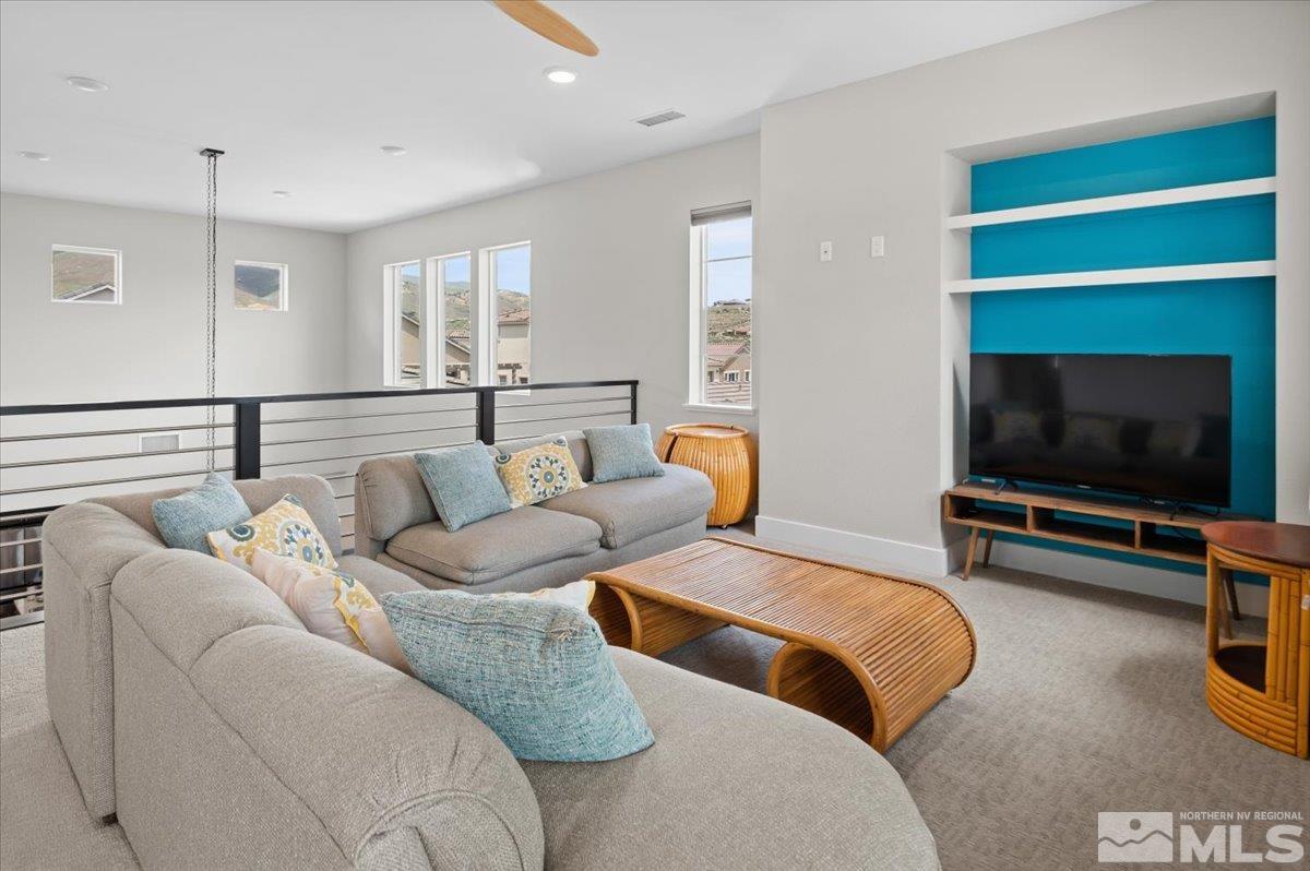 8773 Larkhaven Trail Reno, NV 89523 - Photo 21 of 38 a living room with furniture and a flat screen tv
