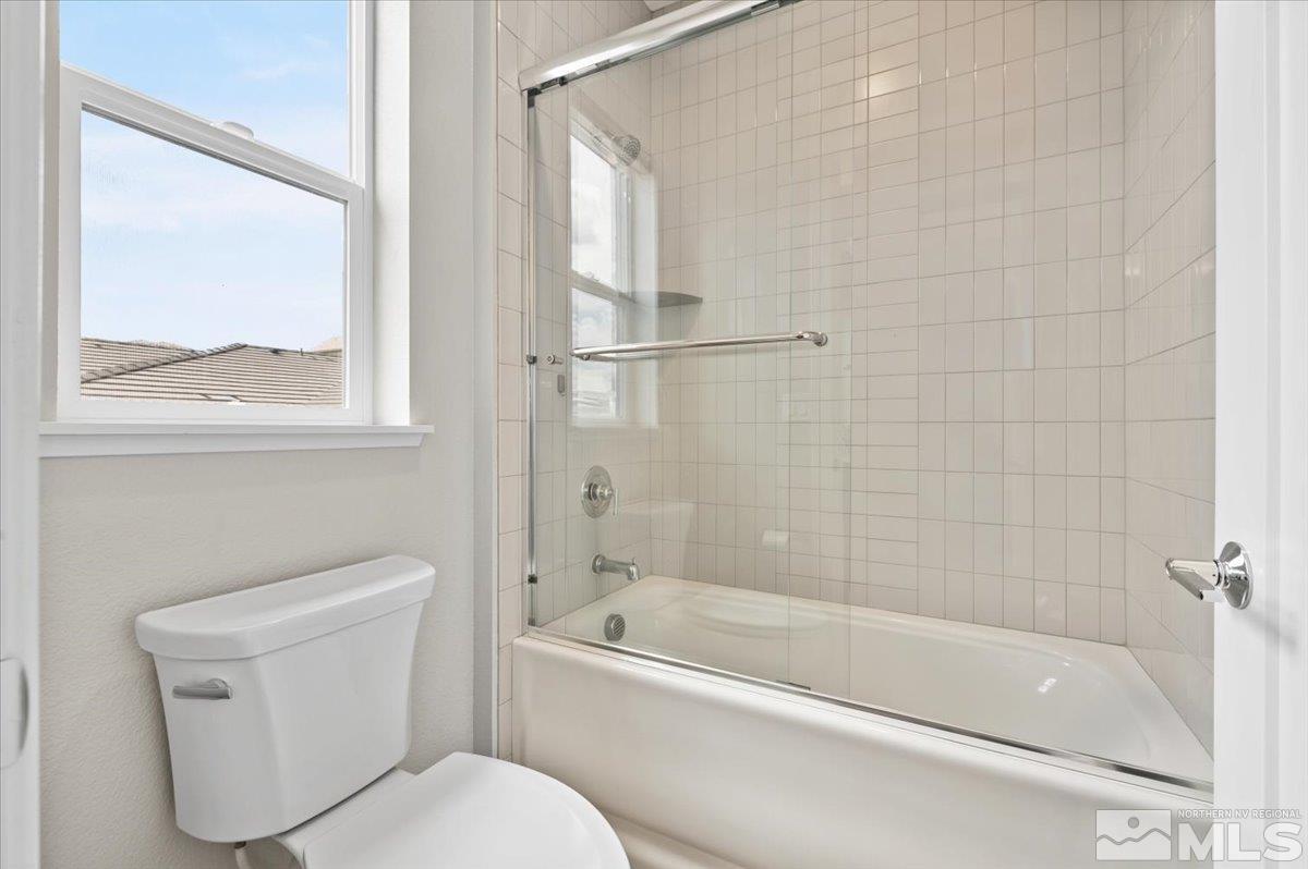 8773 Larkhaven Trail Reno, NV 89523 - Photo 32 of 38 a white bath tub sitting next to a toilet