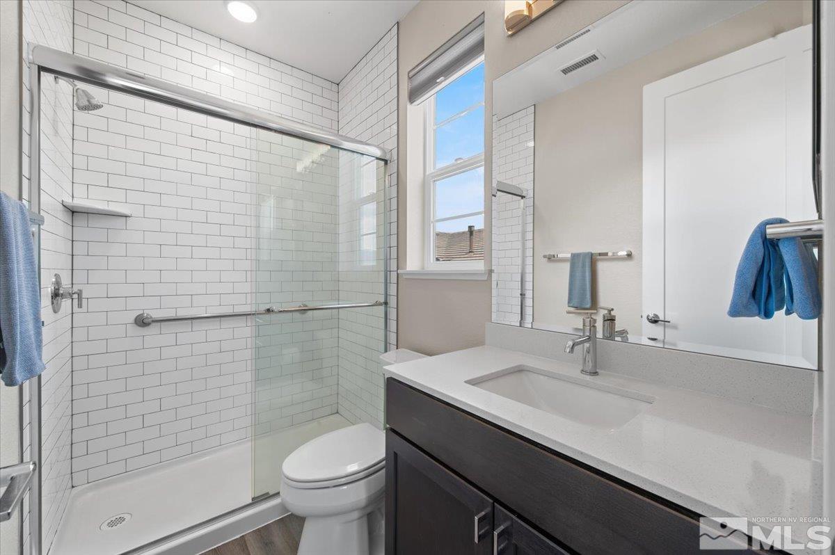 8773 Larkhaven Trail Reno, NV 89523 - Photo 34 of 38 a bathroom with a sink a toilet and shower