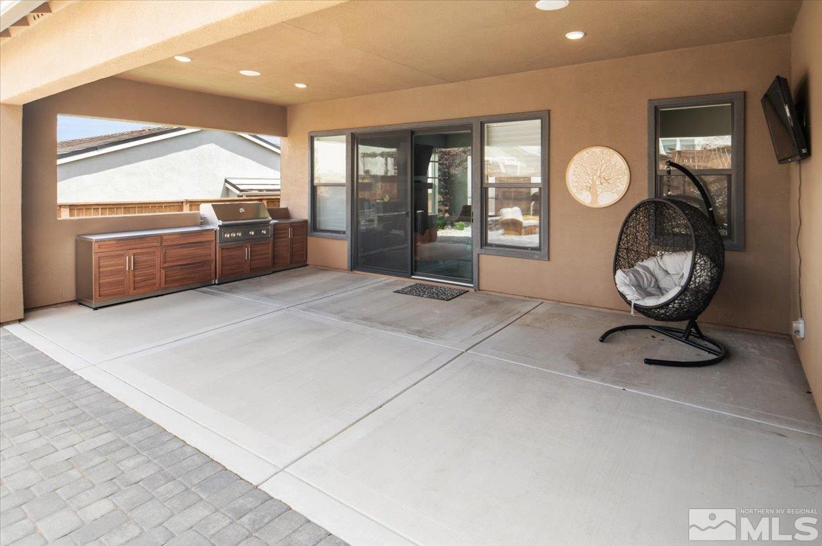 8773 Larkhaven Trail Reno, NV 89523 - Photo 36 of 38 a view of a livingroom with kitchen and wooden floor