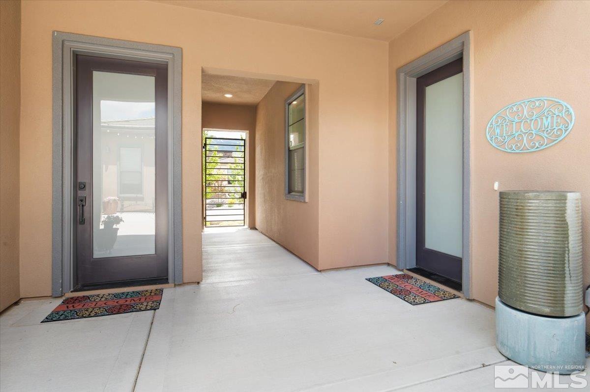 8773 Larkhaven Trail Reno, NV 89523 - Photo 4 of 38 a view of a hallway with wooden floor and glass windows