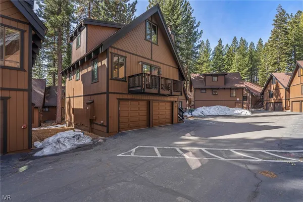 a view of a house with a snow in the road