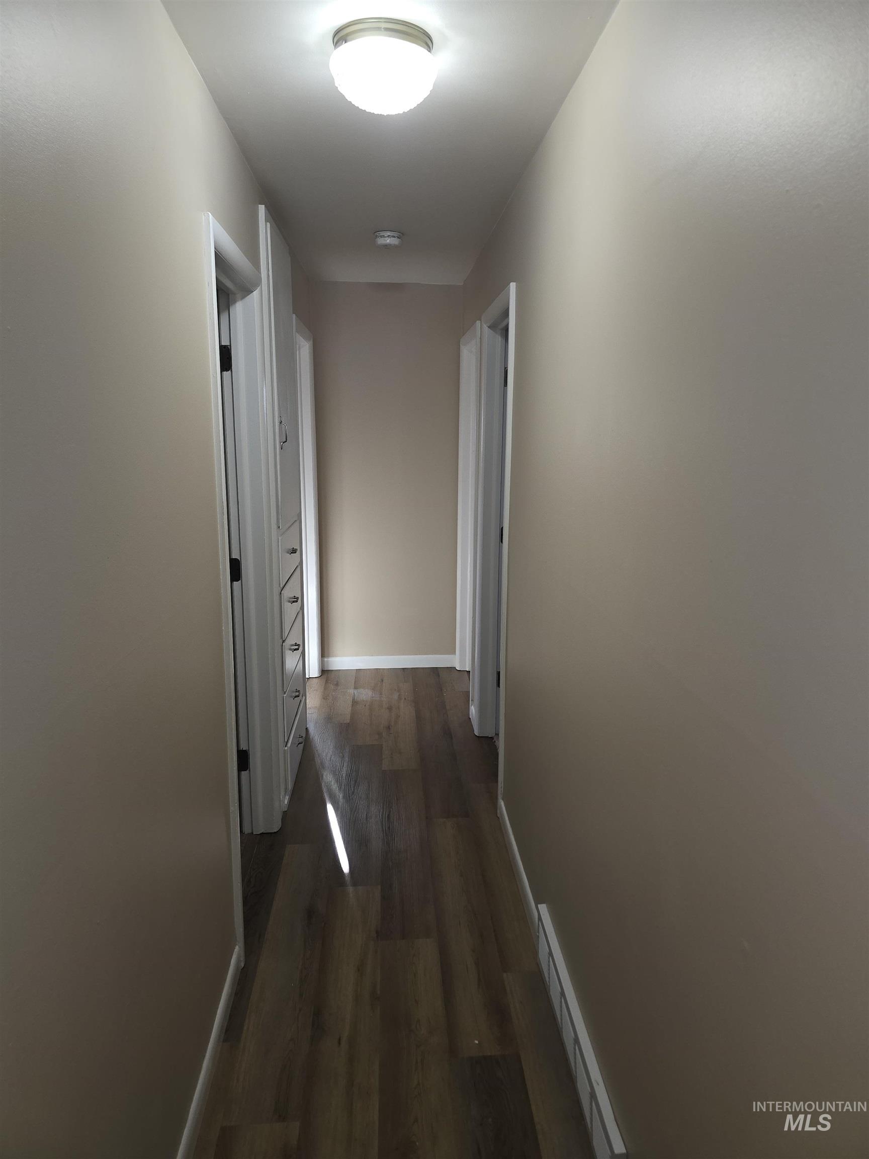 1818 Granada Drive Twin Falls, ID 83301 - Photo 11 of 16 Corridor featuring wood finished floors and a baseboard heating unit