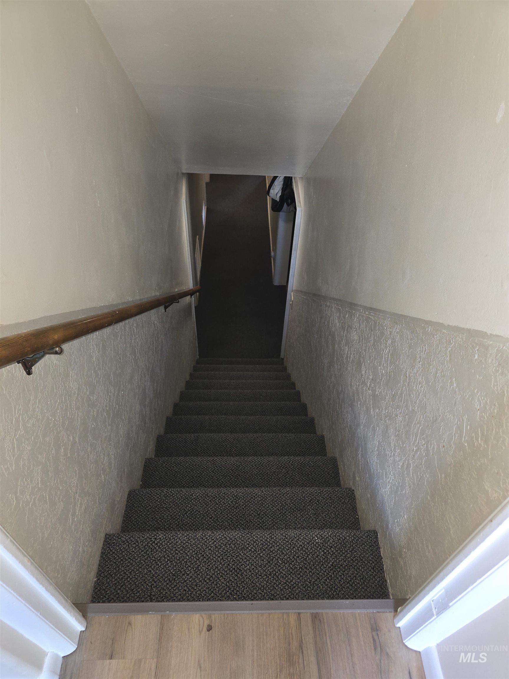 1818 Granada Drive Twin Falls, ID 83301 - Photo 16 of 16 Stairs featuring wood finished floors and a textured wall