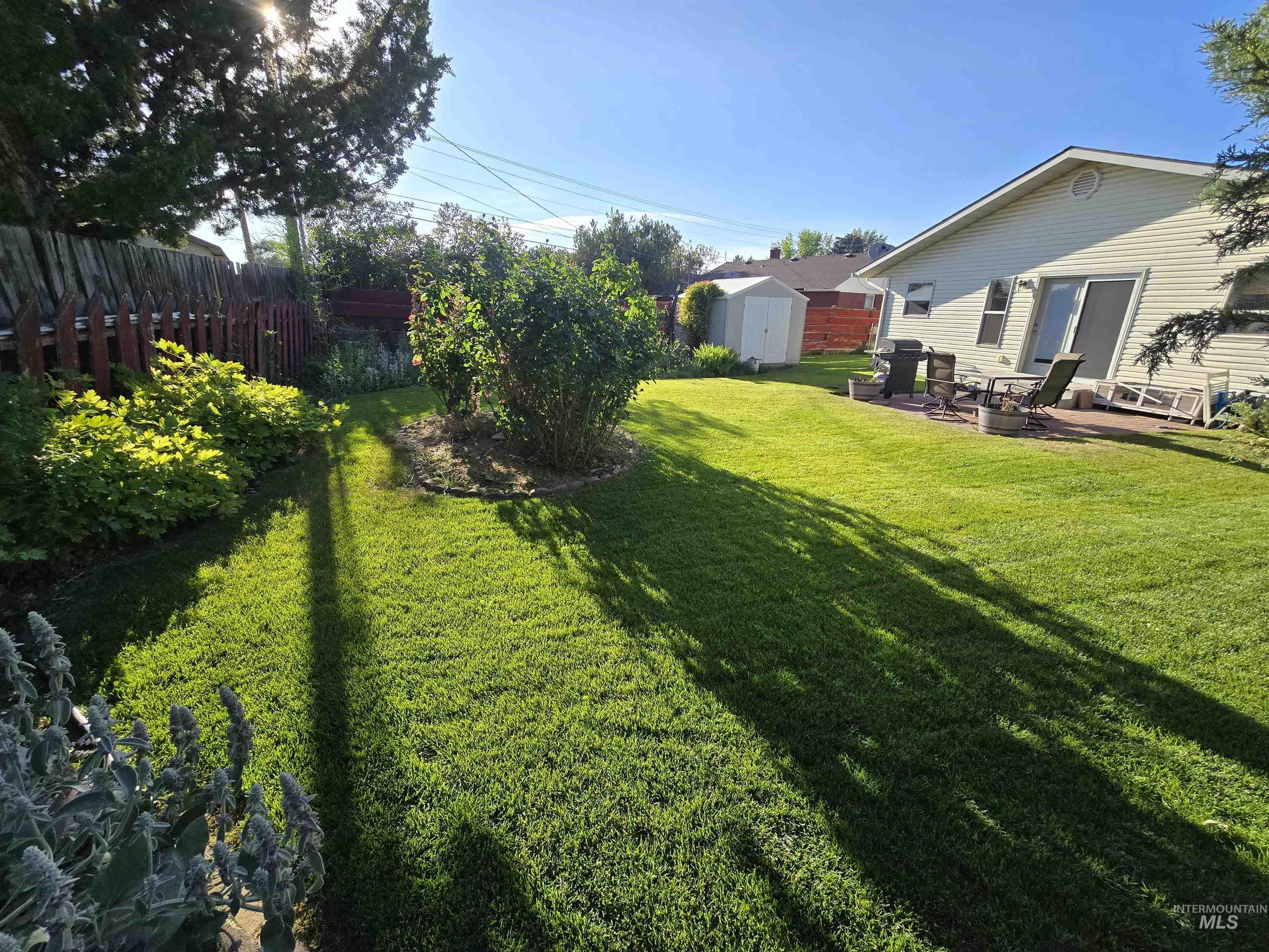 1818 Granada Drive Twin Falls, ID 83301 - Photo 4 of 16 View of yard featuring a storage unit and a patio area
