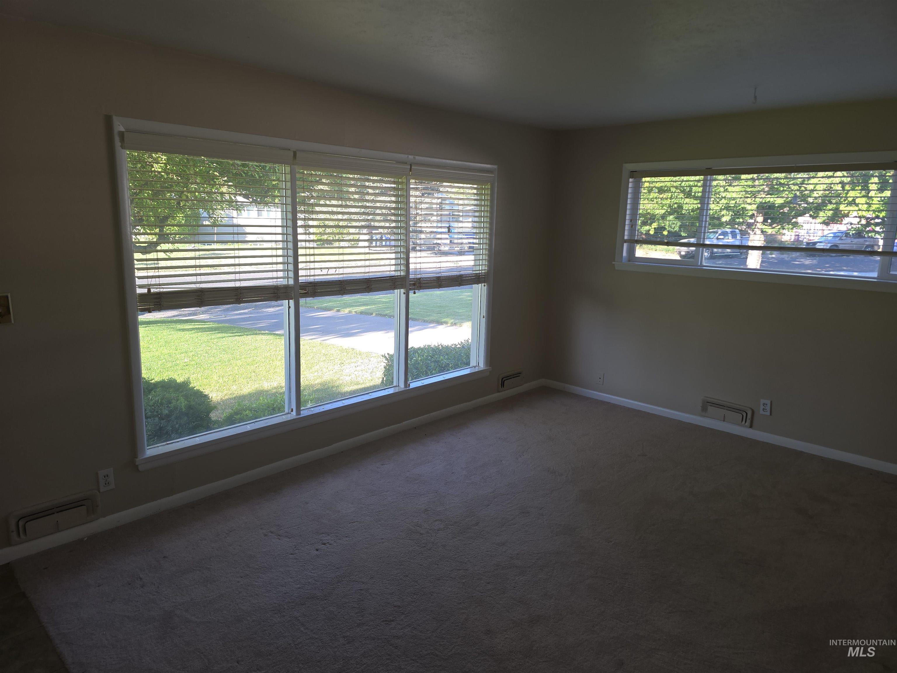 1818 Granada Drive Twin Falls, ID 83301 - Photo 5 of 16 Carpeted empty room featuring baseboards and a baseboard radiator