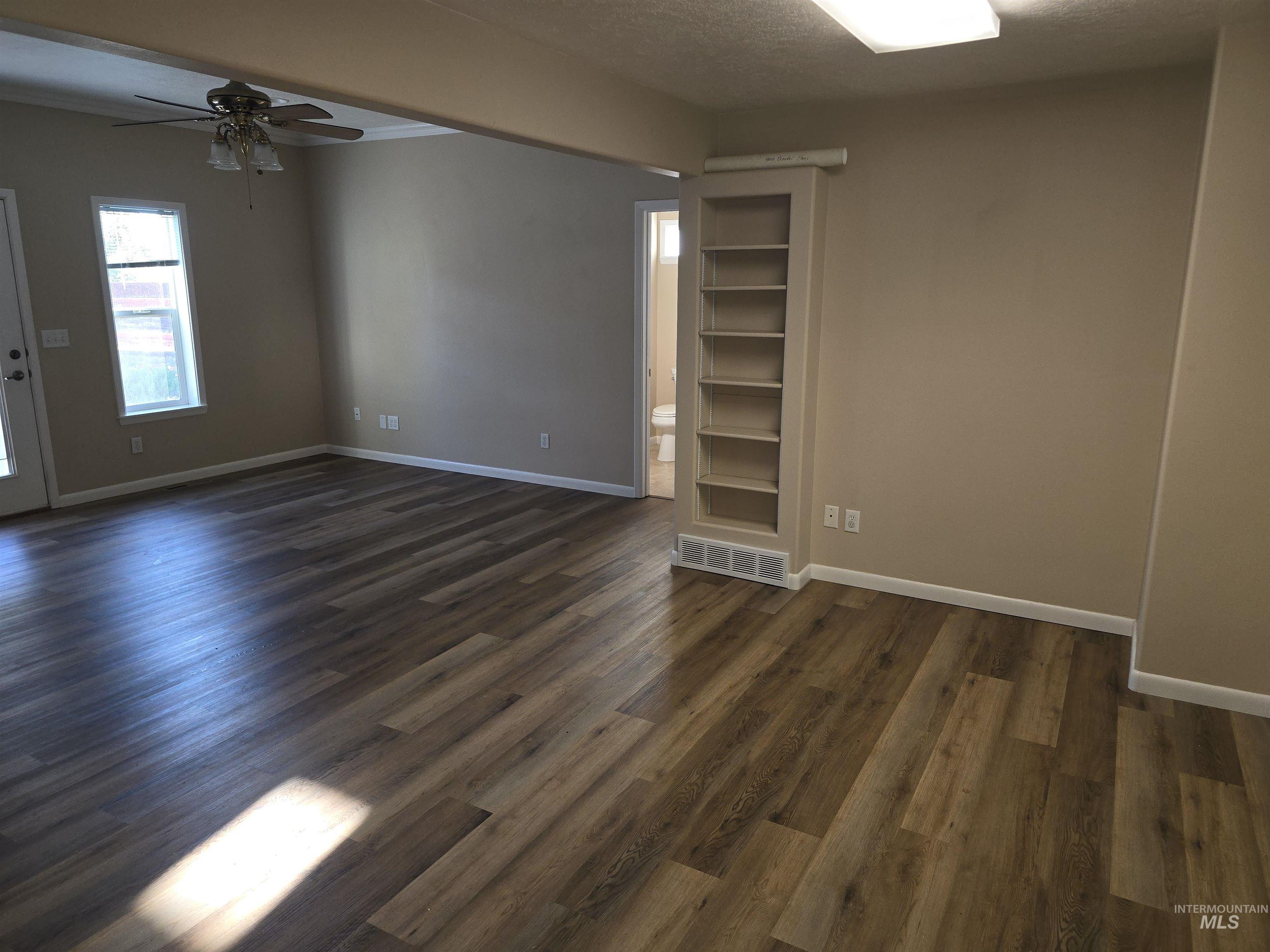 1818 Granada Drive Twin Falls, ID 83301 - Photo 8 of 16 Unfurnished room featuring a ceiling fan and dark wood-style flooring