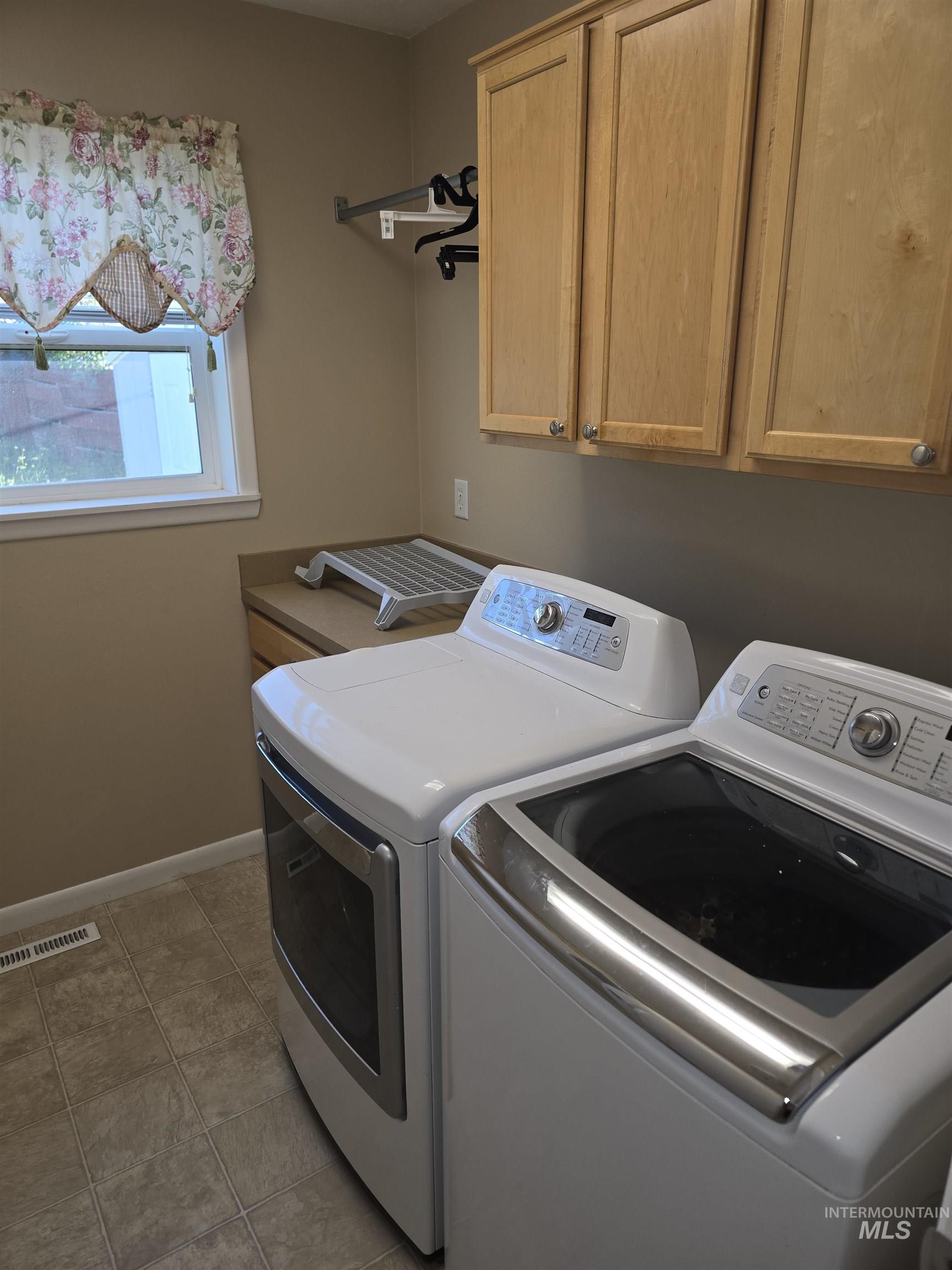 1818 Granada Drive Twin Falls, ID 83301 - Photo 10 of 16 Washroom with cabinet space, washer and dryer, and tile patterned floors