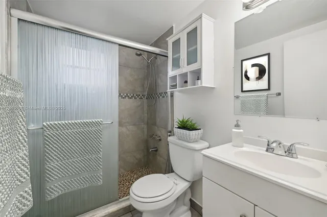 a bathroom with a sink toilet and shower
