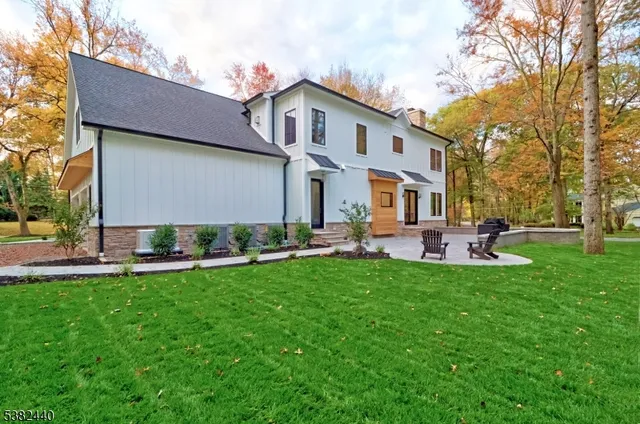 a house view with swimming pool and garden space