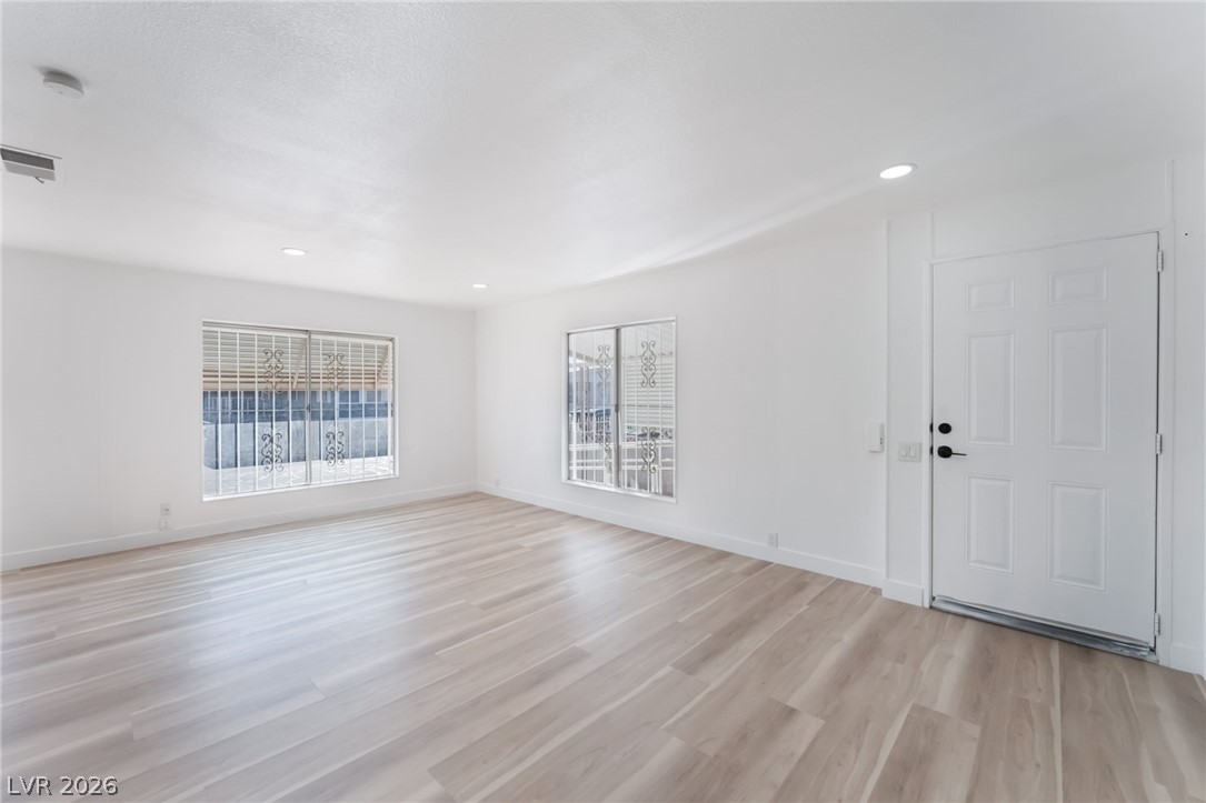 4980 Ridge Drive Las Vegas, NV 89103 - Photo 7 of 36 Unfurnished living room featuring light wood-type flooring and recessed lighting