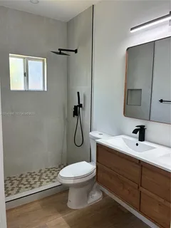 a bathroom with a toilet sink shower