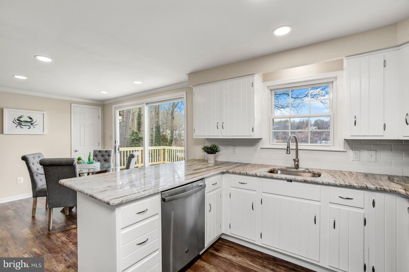 2732 Cedar Drive Riva, MD 21140 - Photo 14 of 30 a kitchen with a sink white cabinets and wooden floors