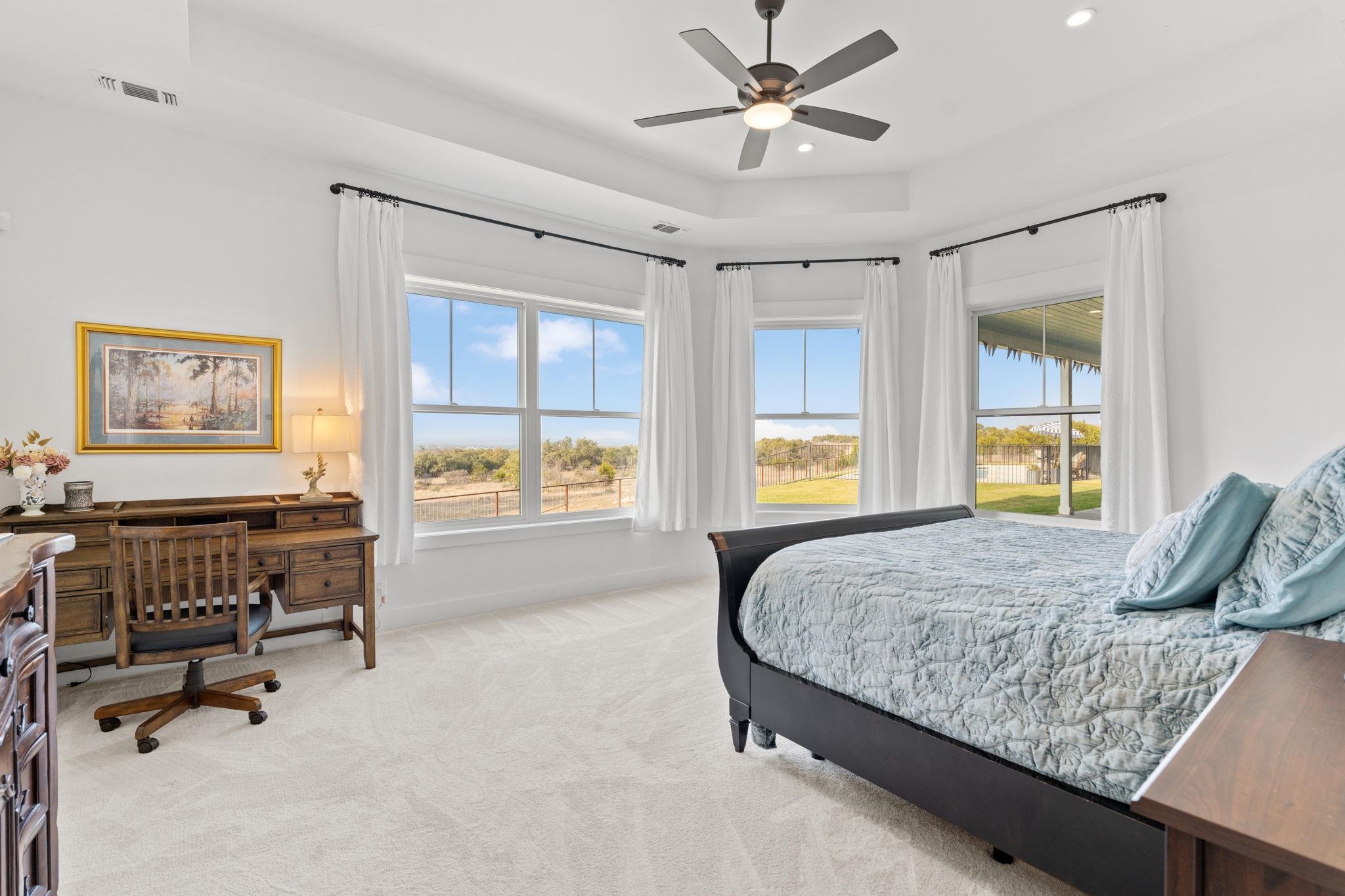 452 Southwick Ranch Road Johnson City, TX 78636 - Photo 12 of 44 a bedroom with a bed and a chandelier