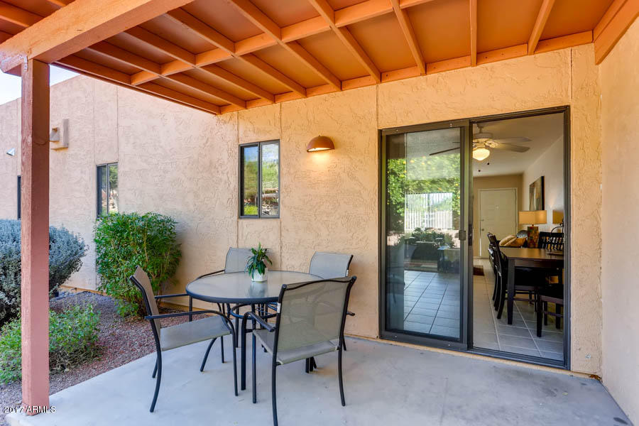 540 South West Road, Unit 26 Wickenburg, AZ 85390 - Photo 8 of 14 a patio with a table and chairs and potted plants