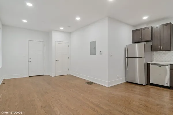 a view of an empty room with a refrigerator