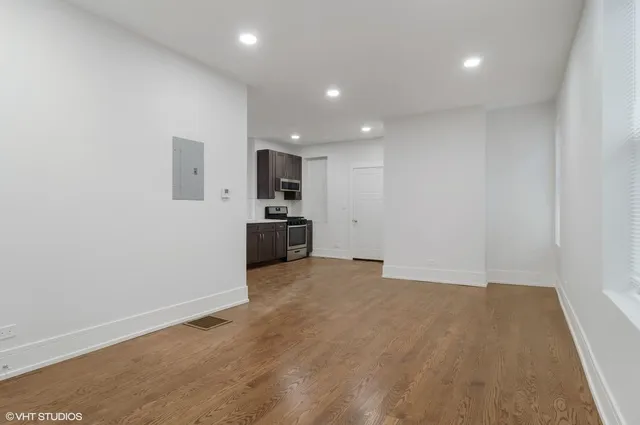 a view of a kitchen with a sink and a refrigerator
