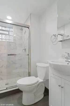a bathroom with a toilet sink and shower