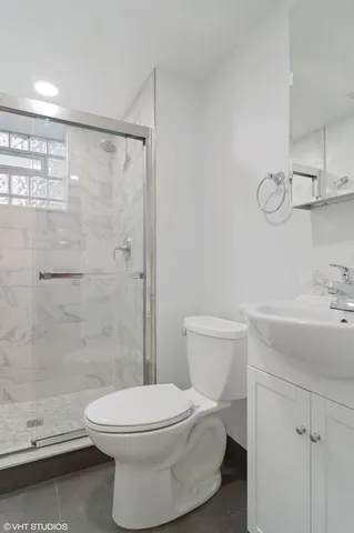 a bathroom with a toilet sink and shower
